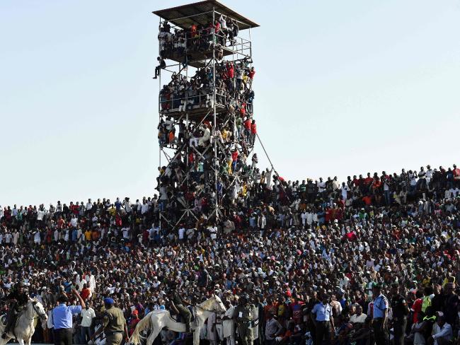 Supporters hanging from a tower.Source:AFP