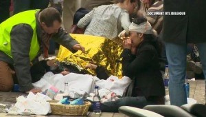 Rescue workers treat victims outside the Maelbeek underground station, in this still image image taken from video, after a blast in Brussels, Belgium, March 22, 2016.  REUTERS/RTL Belgium via Reuters TV