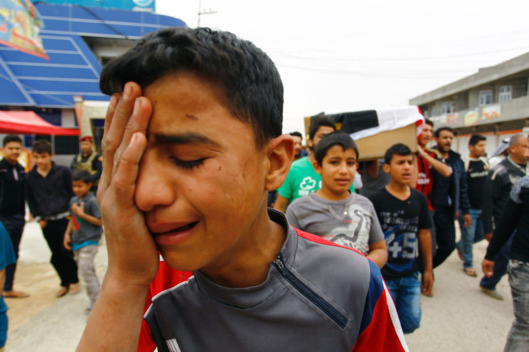 A young Iraqi mourns during a funeral for some of the bombing victims on Saturday. Photo: Haidar Hamdani/AFP/Getty Images