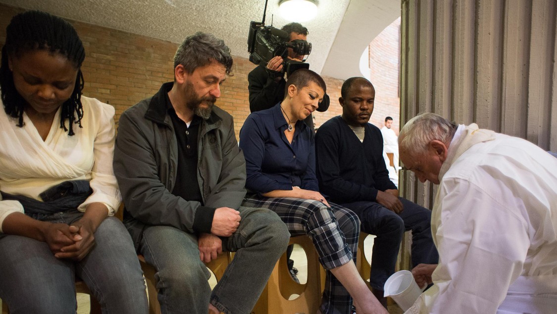 File photo: Pope Francis, right, washes the feet of prisoners.