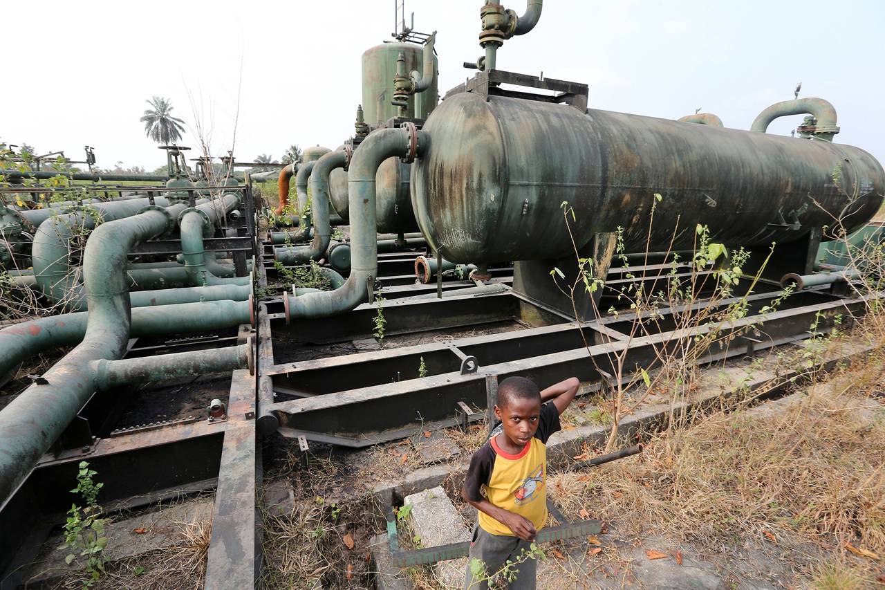 Children play on broken pipework at an abandoned oil-flow station operated by Royal Dutch Shell in K-Dare, Nigeria. 