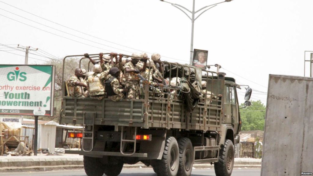 FILE - Soldiers are seen on a truck along a road in Maiduguri in Borno State, Nigeria.