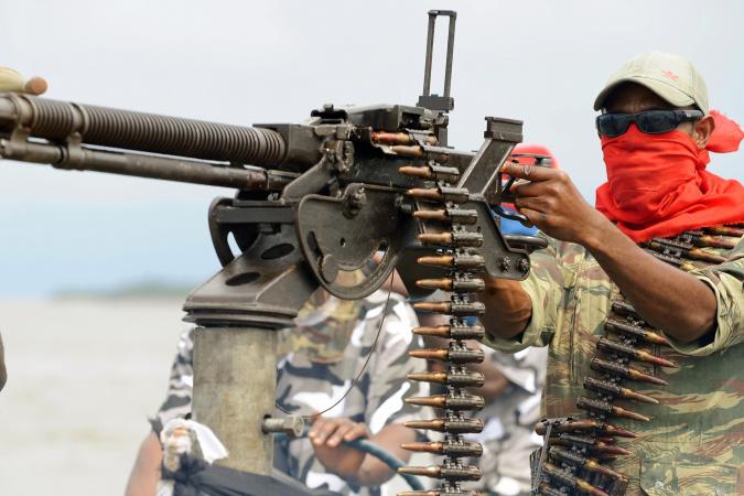 A militant of the Movement for the Emancipation of the Niger Delta (MEND) poses with a heavy machine-gun in the Niger Delta, Nigeria, September 17, 2008. A former MEND leader, known as Tompolo, has been on the run since January. PIUS UTOMI EKPEI/AFP/Getty Images