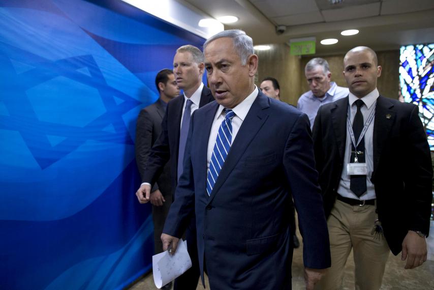 Israeli Prime Minister Benjamin Netanyahu (front) arrives at the weekly cabinet meeting in Jerusalem, March 27, 2016.