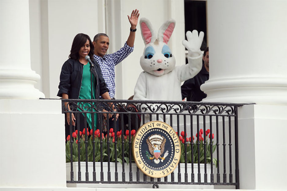 The Obamas wave from the Truman Balcony of the White House.