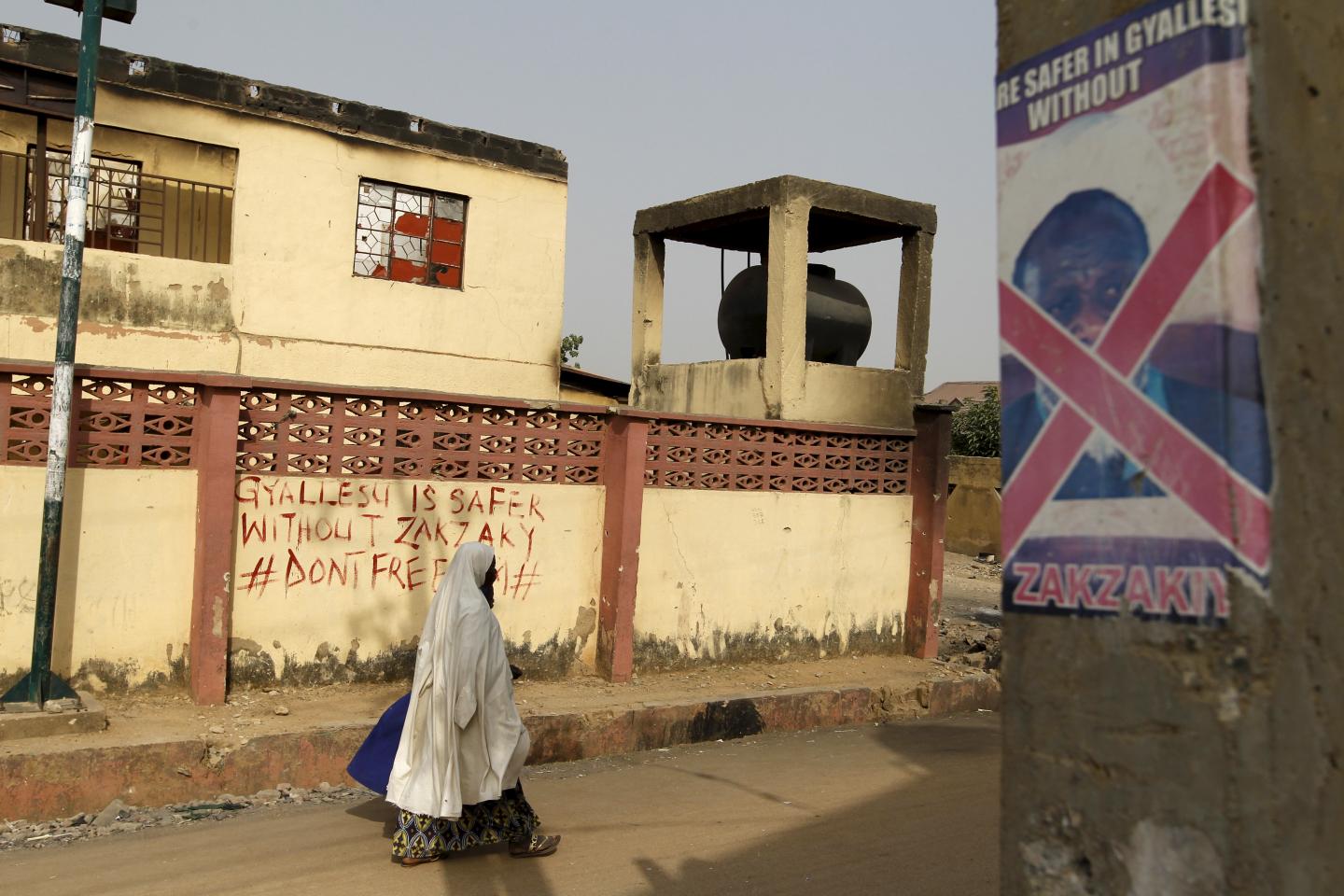 A woman walks past anti-Zakzaky graffiti in the Gyallesu district of Zaria, Nigeria, February 3. The clashes between Zakzaky's movement and the army have stoked tensions in northern Nigeria.