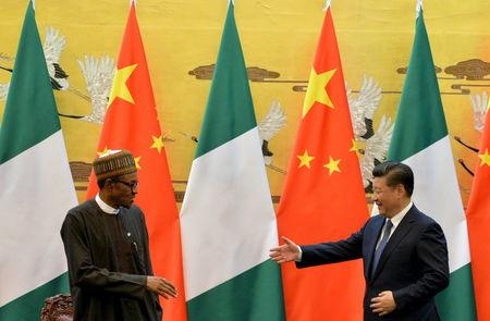 President of the Federal Republic of Nigeria, Muhammadu Buhari (L) and Chinese President, Xi Jinping shake hands during a signing ceremony at the Great Hall of the People in Beijing, April 12, 2016. REUTERS/Kenzaburo Fukuhara/Pool