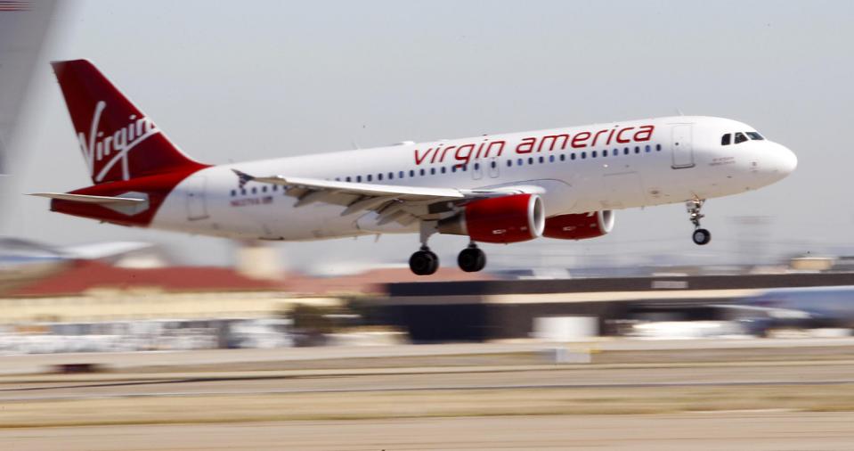 FILE - In this Dec. 1, 2010, file photo, Virgin America's inaugural flight between Los Angeles and Dallas Fort Worth International Airport comes in for a landing in Grapevine, Texas. Alaska Air Group Inc. is buying Virgin America in a deal worth more than $2 billion, creating a powerhouse airline with an expanded West Coast presence. Alaska Air said Monday, April 4, 2016, that the deal will expand its route network. (AP Photo/LM Otero, File)