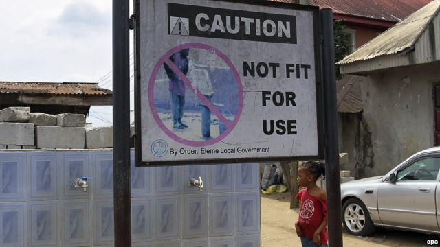 A sign warning against a water source contaminated by oil in the Ogale community in the oil rich Niger Delta, Nigeria, March 9, 2016. 