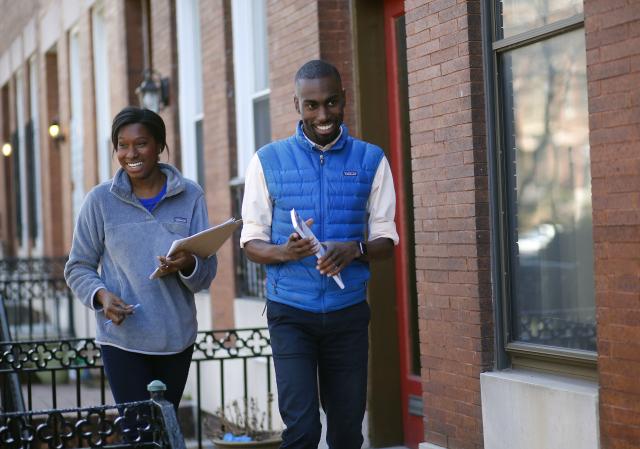 Mayoral candidate DeRay Mckesson, right, and campaign staffer Maria Griffin canvass in the Charles Village neighborhood of Baltimore on March 26, 2016. 