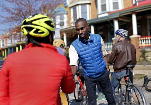 Mckesson chats with bicyclists as he canvasses in Charles Village, Baltimore, on March 26, 2016. (AP Photo/Patrick Semansky) 