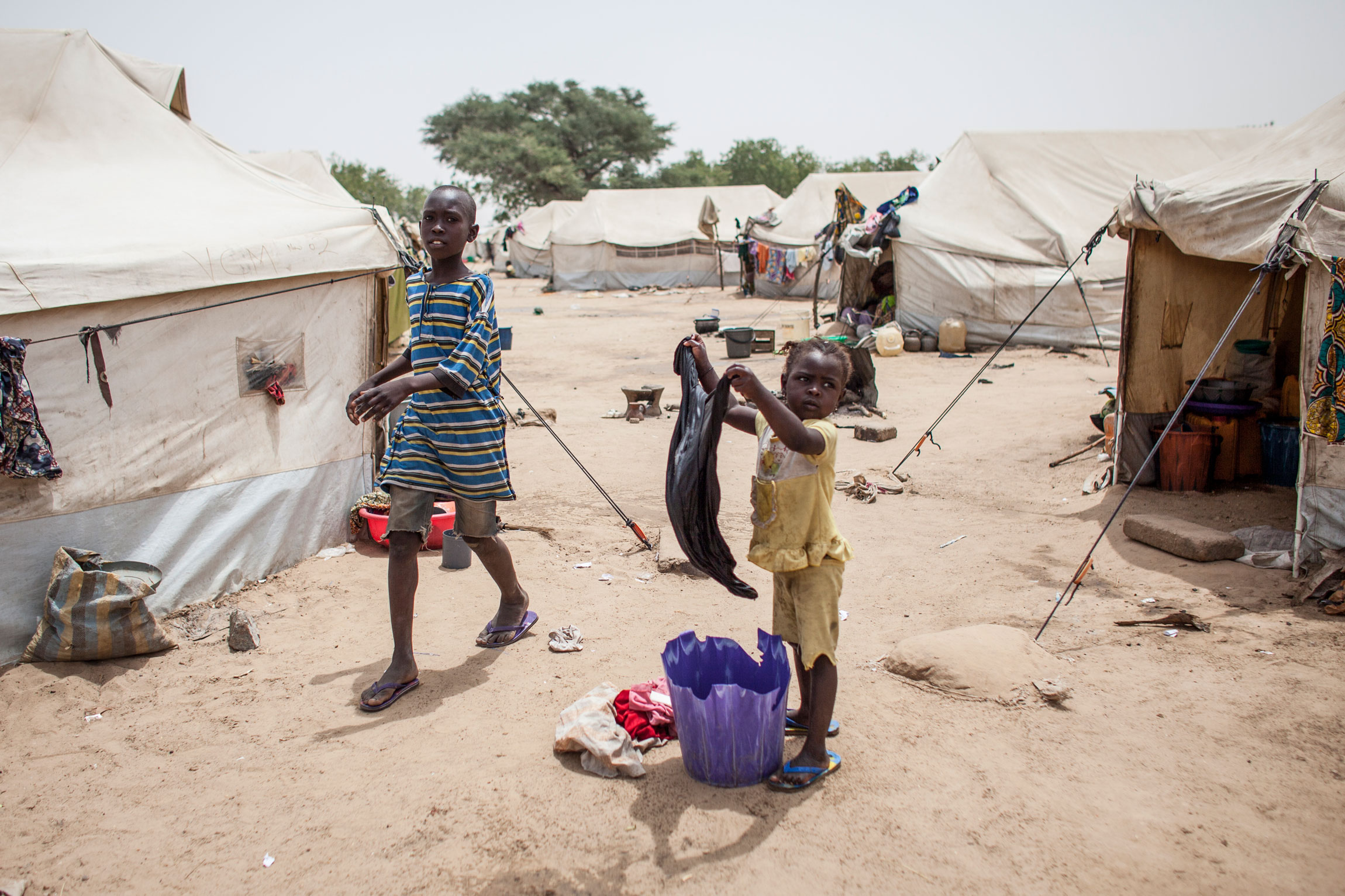 A girl does laundry in the Dalori camp for internally displaced persons in Maiduguri, Nigeria, which houses close to 20,000 people. (Jane Hahn for the Washington Post)