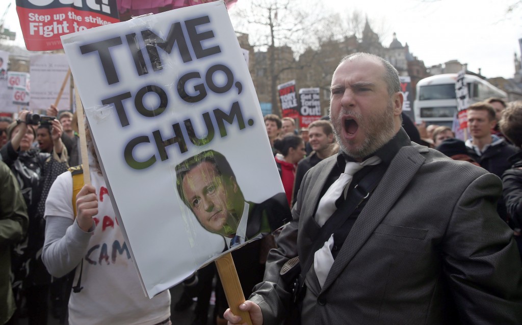 Demonstrators hold placards during a protest outside Downing Street in Whitehall, central London, Britain April 9, 2016. British Prime Minister David Cameron said on Saturday said he should have handled scrutiny of his family’s tax arrangements better and promised to learn the lessons after days of negative media coverage and calls for his resignation. Photo by Neil Hall/Reuters