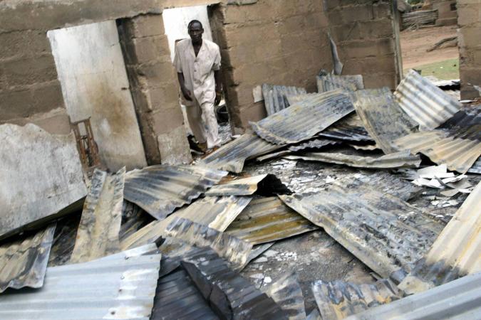 A pastor surveys the rubble of a church torched by rampaging Hausa-Fulani herdsmen in Sabon Gida, Nigeria on May 21, 2004. The ongoing conflict in Nigeria between herdsmen and settled communities has killed hundreds in 2016.