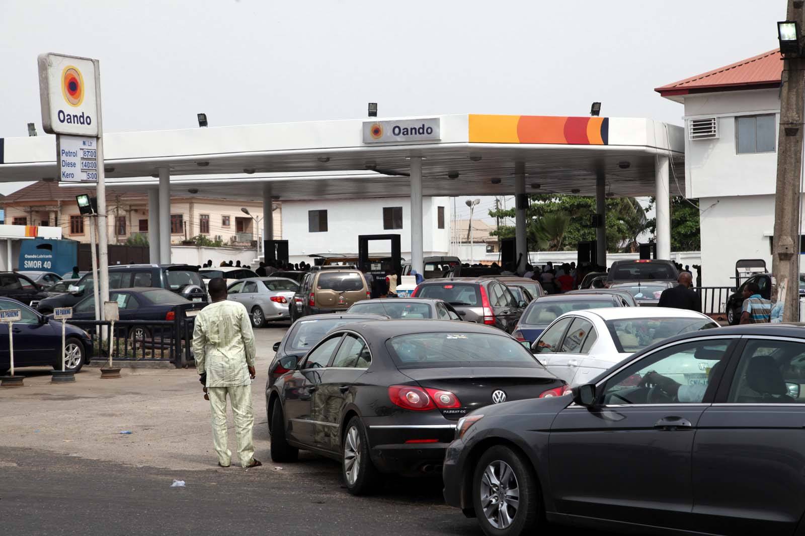 Back home, Africa’s top oil producer is unable to import enough gasoline. Drivers in this city of 21 million have spent days inching through miles-long lines to fill their tanks at the few pumps still operating.