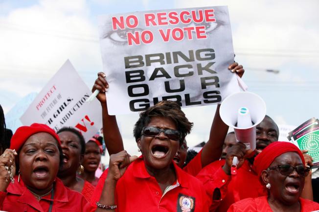 FILE- In this Monday, May 5, 2014 file photo, women attend a demonstration in Lagos calling on the government to rescue kidnapped school girls of a government secondary school in Chibok, Nigeria. A school mate says she cried with joy when she saw a Boko Haram video appearing to show some of Nigeria's kidnapped Chibok girls, with images of tearful parents recognizing their daughters, who have not been heard from since the mass abduction by the Islamic extremist group Boko Haram two years ago. (AP Photo/ Sunday Alamba, File)