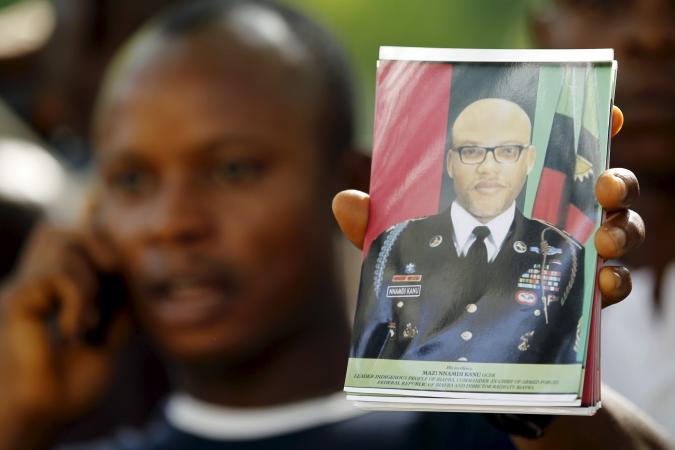 A supporter of pro-Biafra leader Nnamdi Kanu holds a photograph of Kanu at a rally in Abuja, Nigeria on December 1, 2015. Kanu has been in detention since October 2015 and his trial has been pushed back until June.