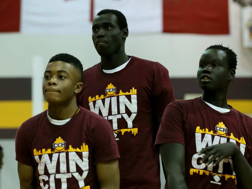 Catholic Central Comets Jonathan Nicola, centre, during warm-ups with teammates Caleb Akinsanya, left, and Ramkel Wah on Jan. 5, 2016.