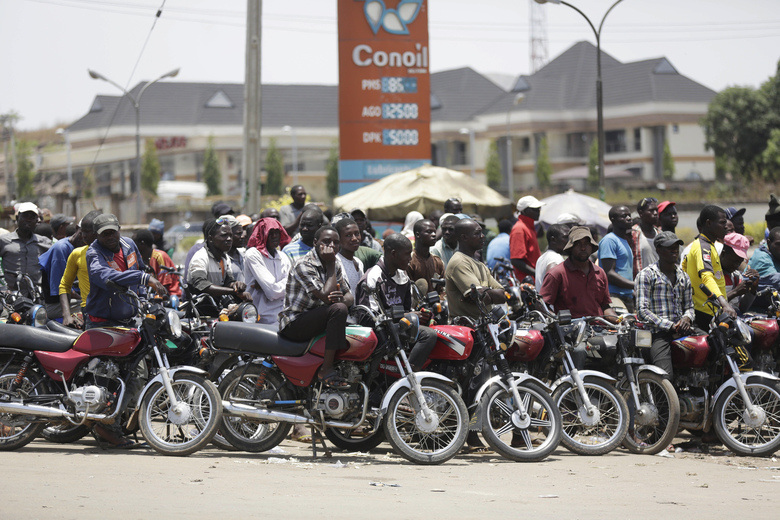 In this photo taken Sunday April 10, 2016, motorcycles wait for fuel at the petrol station in Abuja, Nigeria. Nigeria's government announced Wednesday May 11, 2016 it is lifting a controversial subsidy on gas, nearly doubling the price amid a massive fuel shortage and militant attacks on oil installations in Africa's biggest petroleum producer. (AP Photo/Sunday Alamba)