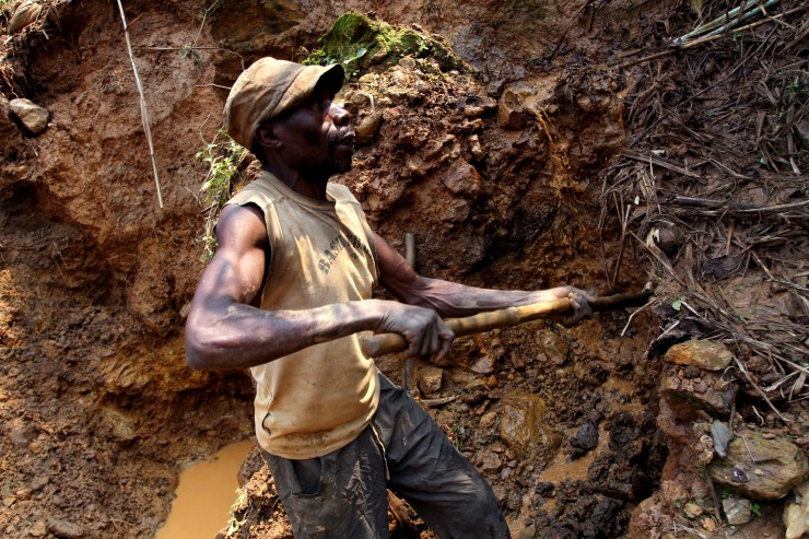 In this photo taken Aug. 17, 2012, one of the few remaining miners digs out soil which will later be filtered for traces of cassiterite, the major ore of tin, at Nyabibwe mine, in eastern Congo. Gold is now the primary source of income for armed groups in eastern Congo, and is ending up in jewelry stores across the world, according to a report published Thursday, Oct. 25, 2012, by the Enough Project. 