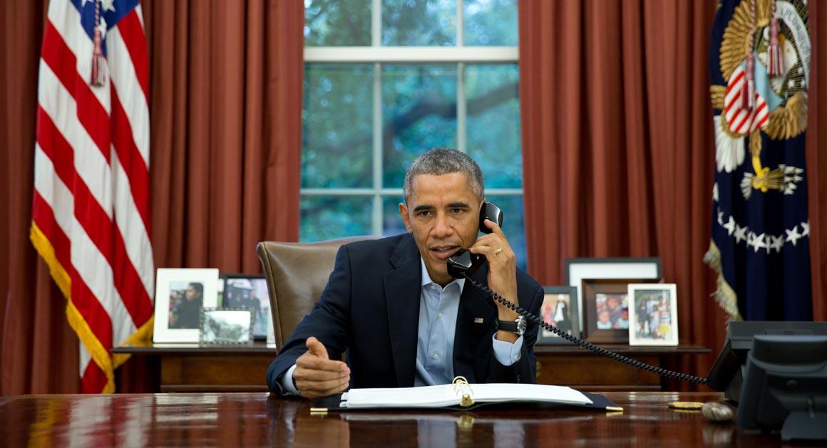 President Barack Obama talks on a conference call from the Oval Office with service members in Liberia and Senegal taking part in Operation United Assistance, the U.S. military campaign to contain the Ebola virus outbreak at its source, Nov. 1, 2014. (Official White House Photo by Pete Souza)