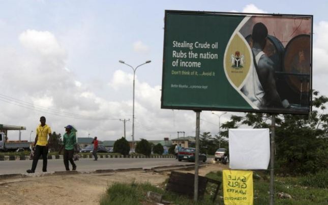 Bleeding the nation - a billboard in Nigeria warning of the consequences of oil theft  Credit: Reuters 