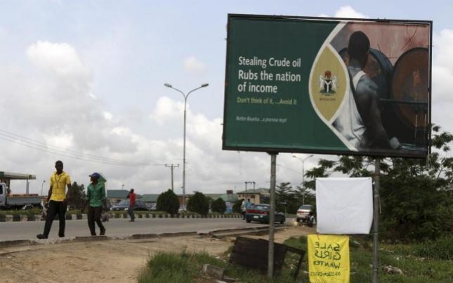 Bleeding the nation - a billboard in Nigeria warning of the consequences of oil theft Credit: Reuters