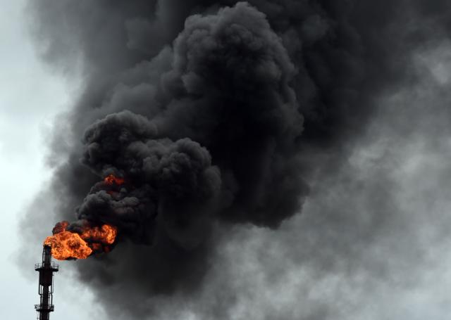 Smoke billows from a refinery in Port Harcourt, southern Nigeria, September 16, 2015. A new militant group calling itself the Niger Delta Avengers is wreaking havoc in Nigeria's oil-producing region. PIUS UTOMI EKPEI/AFP/Getty Images