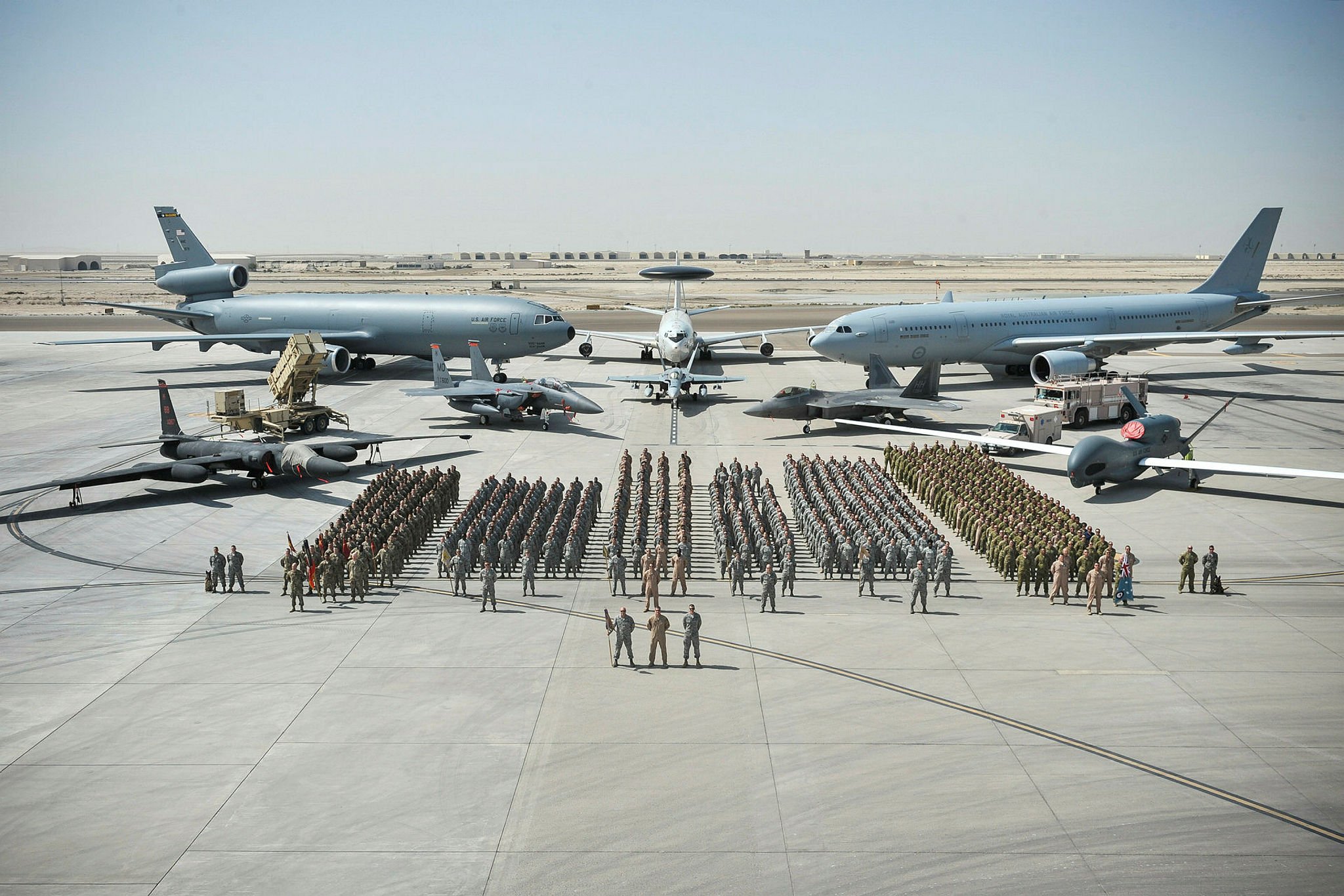 In the photo below, soldiers and airmen from the international coalition to thwart ISIS stand in front of some of the most powerful military aircraft in the world. From left to right, we see a U-2 spy plane, a KC-10 tanker, an F-15 Eagle, an F-18 jet in front of an E-3, a KC-30A tanker, an F-22 Raptor, and an RQ-4 Global Hawk drone.From left to right, we see a U-2 spy plane, a KC-10 tanker, an F-15 Eagle, an F-18 jet in front of an E-3, a KC-30A tanker, an F-22 Raptor, and an RQ-4 Global Hawk drone.