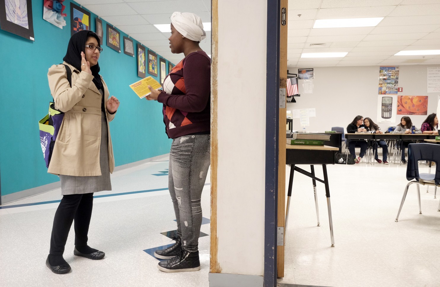 Raaheela Ahmed, 22, speaks with Lindsey Adva, 17, at Northwestern High School in Hyattsville, Md. Ahmed, who is running for a seat on the Prince George’s County Board of Education, is one of several young Muslim women getting involved in local politics. (Bonnie Jo Mount/The Washington Post) 