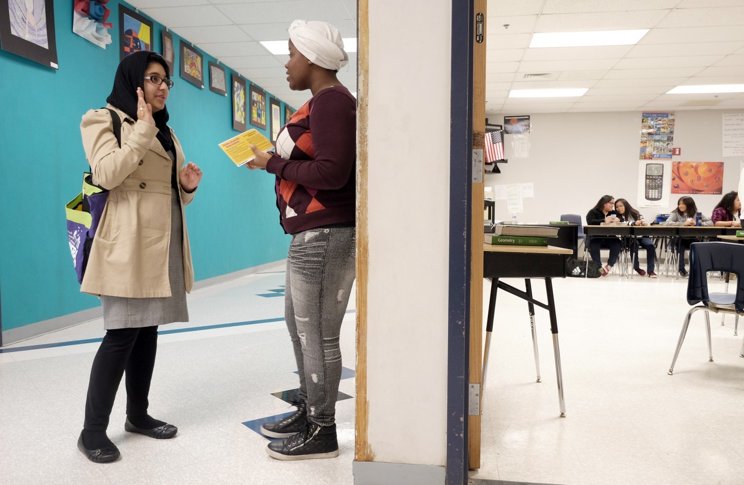 Raaheela Ahmed, 22, speaks with Lindsey Adva, 17, at Northwestern High School in Hyattsville, Md. Ahmed, who is running for a seat on the Prince George’s County Board of Education, is one of several young Muslim women getting involved in local politics. (Bonnie Jo Mount/The Washington Post)