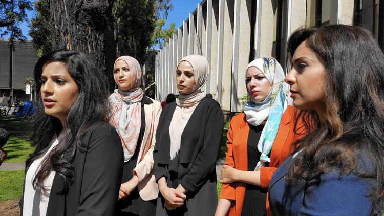 Sara Farsakh, 29, left, stands with three other plaintiffs and one of their lawyers. The women are suing Urth Caffe in Laguna Beach for discrimination, alleging they were targeted in April for being "visibly Muslim."  (Anh Do / Los Angeles Times)