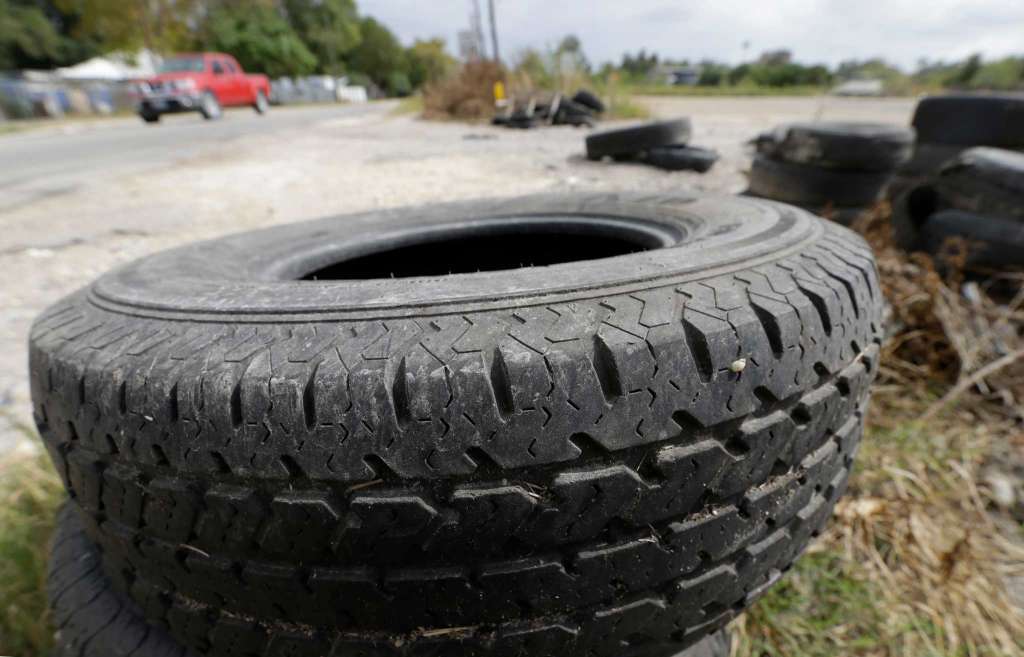 Photo culled from the Houston Chronicle shows tires discarded along Laura Koppe Road at Jensen Street, one of thousands of illegal dumps.