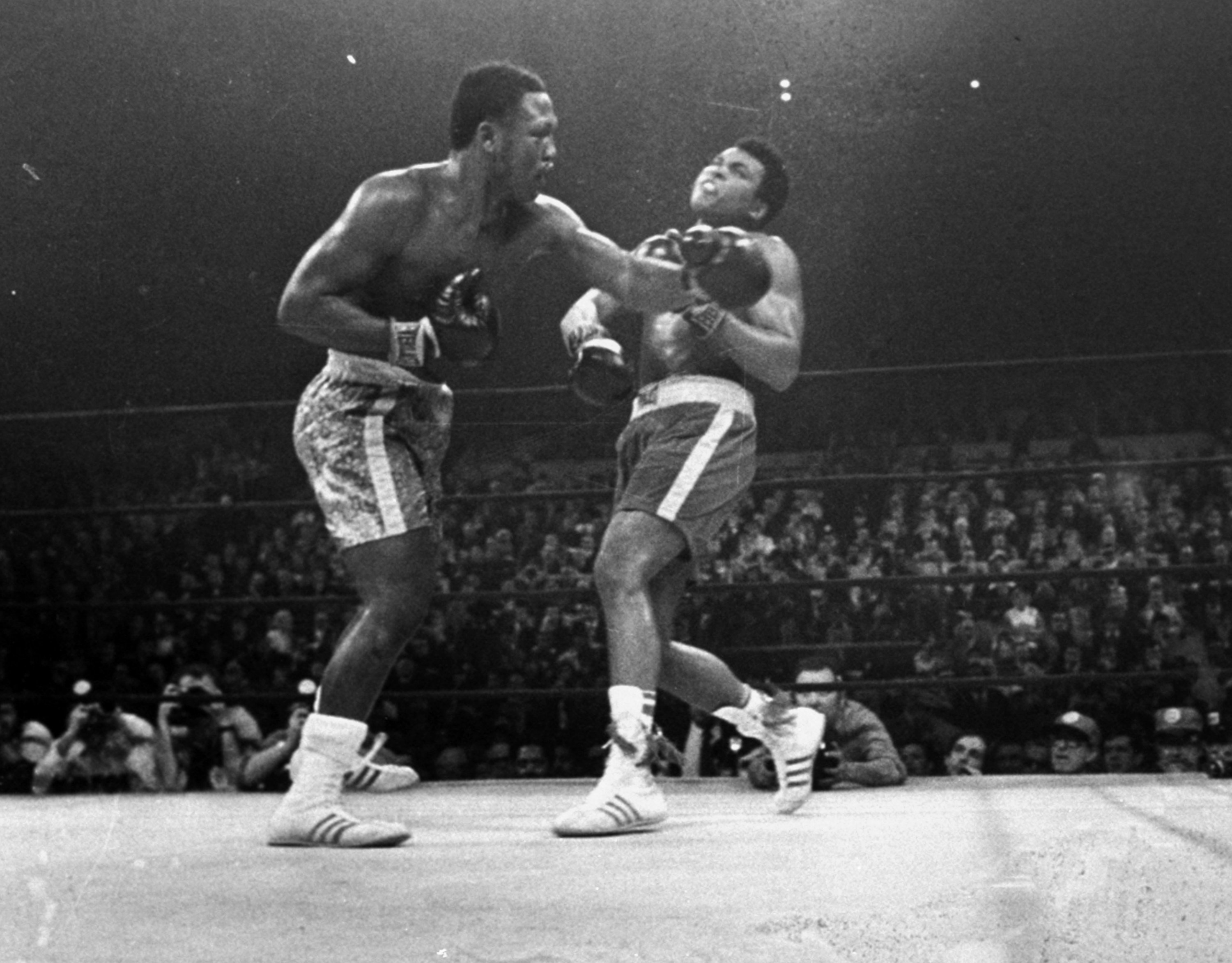 FILE - In this March 8, 1971, file photo, boxer Joe Frazier, left, hits Muhammad Ali during the 15th round of their heavyweight title fight at New York's Madison Square Garden. Michigan States offensive line expects a fight when it plays Alabamas talented defensive line on Thursday night, Dec. 31, 2015 in the Cotton Bowl. So why not prepare by watching one of the greatest fights of all time? Michigan State offensive line coach Mark Staten had his unit watch and score the 1971 Muhammad Ali-Joe Frazier heavyweight title match dubbed the Fight of the Century. (AP Photo, File)