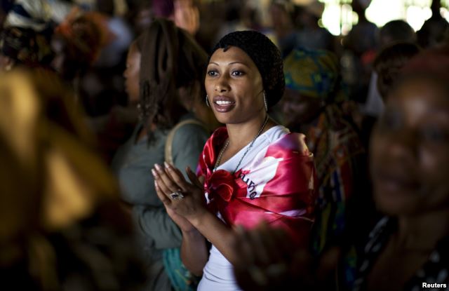 FILE - A woman sings during a prayer session at the Saint Francis Xavier parish, part of the fraternity Ephphata charismatic awakening branch of the Catholic church, ahead of the arrival on Tuesday of Pope Benedict XVI in Yaounde March 17, 2009.