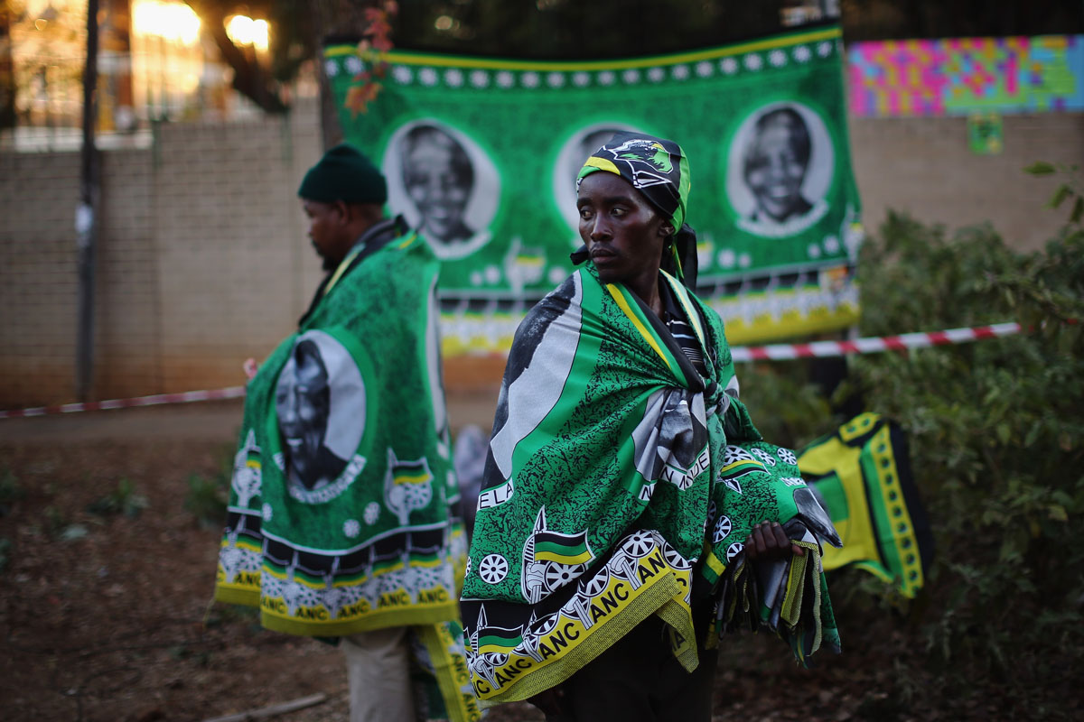 PRETORIA, SOUTH AFRICA - JUNE 29:  Vendors sell ANC flags depicting Nelson Mandela outside the MediClinic Heart hospital where former South African President Nelson Mandela is being treated on June 29, 2013 in Pretoria. US President Barack Obama met with the former South African leader's family to offer prayers as Mandela continues to be treated for a lung infection.  (Photo by Dan Kitwood/Getty Images) ORG XMIT: 172091911