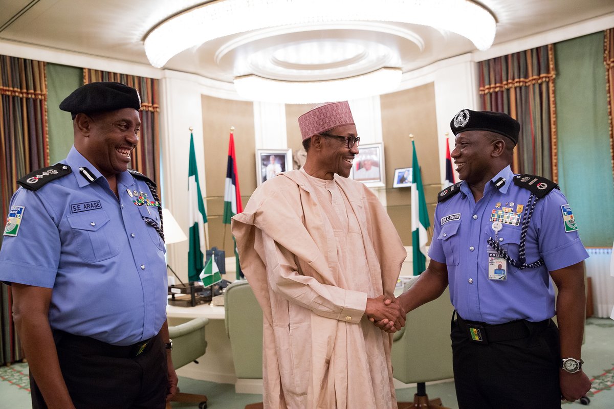 President Buhari congratulates Ibrahim Kpotun Idris. Mr. Idris (right) replaces Solomon Arase (left) who retires today. 