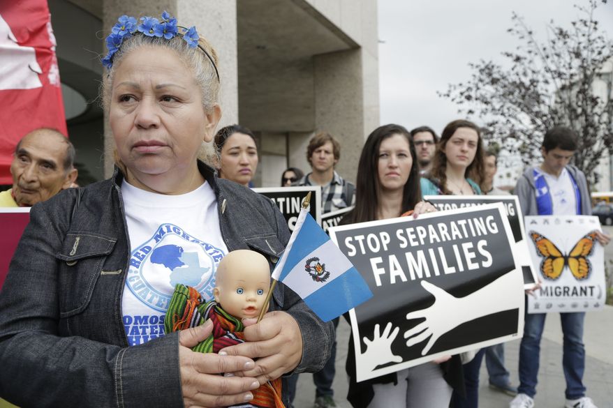 Guatemalan immigrant Amariliz Ortiz holds a doll as she joins families impacted by the immigration raids during a rally with Members of the Coalition for Humane Immigrant Rights of Los Angeles, CHIRLA, outside the ICE Metropolitan Detention Center downtown Los Angeles, Tuesday, May 17, 2016. Families rally to call on the Obama Administration to grant Temporary Protected Status, TPS, to Central American women and children seeking refuge in the U.S. (AP Photo/Nick Ut) 