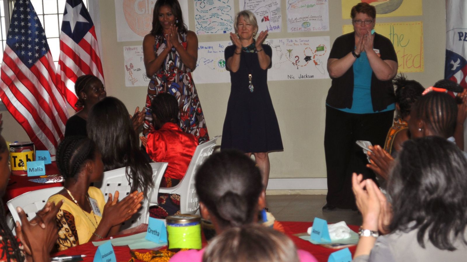 U.S. first lady Michelle Obama, centre, is welcomed by Peace Corp teachers and students at a project 70 kilometers (43 miles) from the capital city Monrovia in Kakata, Liberia, Monday, June 27, 2016. Michelle Obama is visiting a leadership camp for girls in Liberia, Monday, the first stop in her latest Africa visit, in a country still recovering from the recent Ebola epidemic that left thousands dead. (AP Photo/Abbas Dulleh)