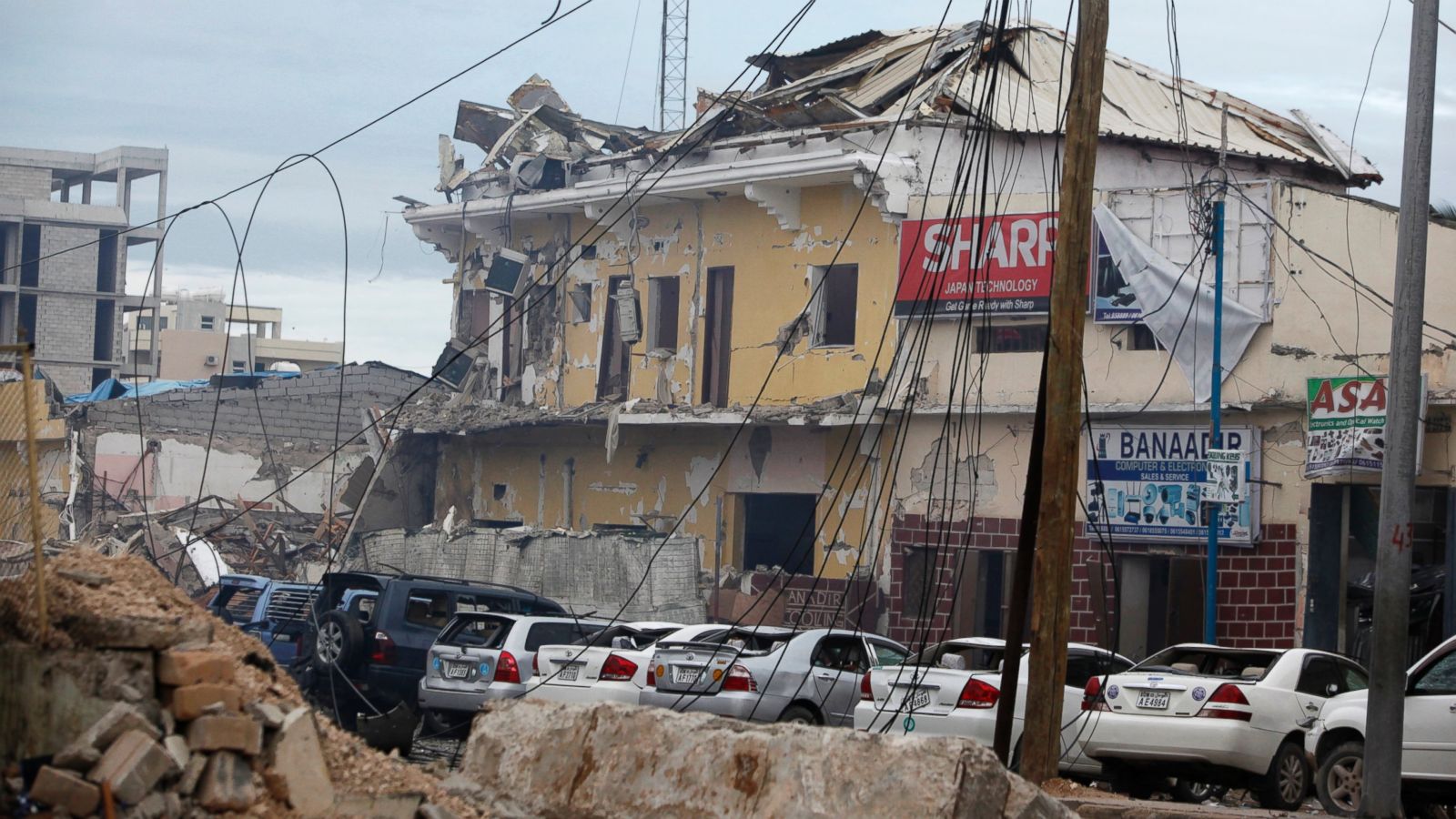 A view of the Nasahablod Hotel, destroyed after a bomb attack in Mogadishu, Somalia, Saturday, June 25, 2016. A Somali police officer says a suicide car bomber detonated an explosives-laden vehicle at the gate of a hotel in Mogadishu followed by gunmen who were fighting their way into the hotel..(AP Photo/Farah Abdi Warsameh)
