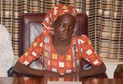 FILE- In this Thursday, May. 19, 2016 file photo, Amina Ali, the rescue Chibok school girl, sits during a meeting with Nigeria's President Muhammadu Buhari at the Presidential palace in Abuja, Nigeria. Nigeria's Bring Back Our Girls movement demanded Wednesday, June. 22, 2016 that the government provide news of the only one of 219 kidnapped schoolgirls to escape the clutches of the Boko Haram extremist group. (AP Photo/Azeez Akunleyan, File)