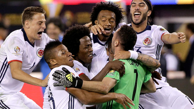 Colombia players celebrate their win over Peru in a Copa America quarterfinal soccer on Friday. (Peter Morgan / Associated Press)