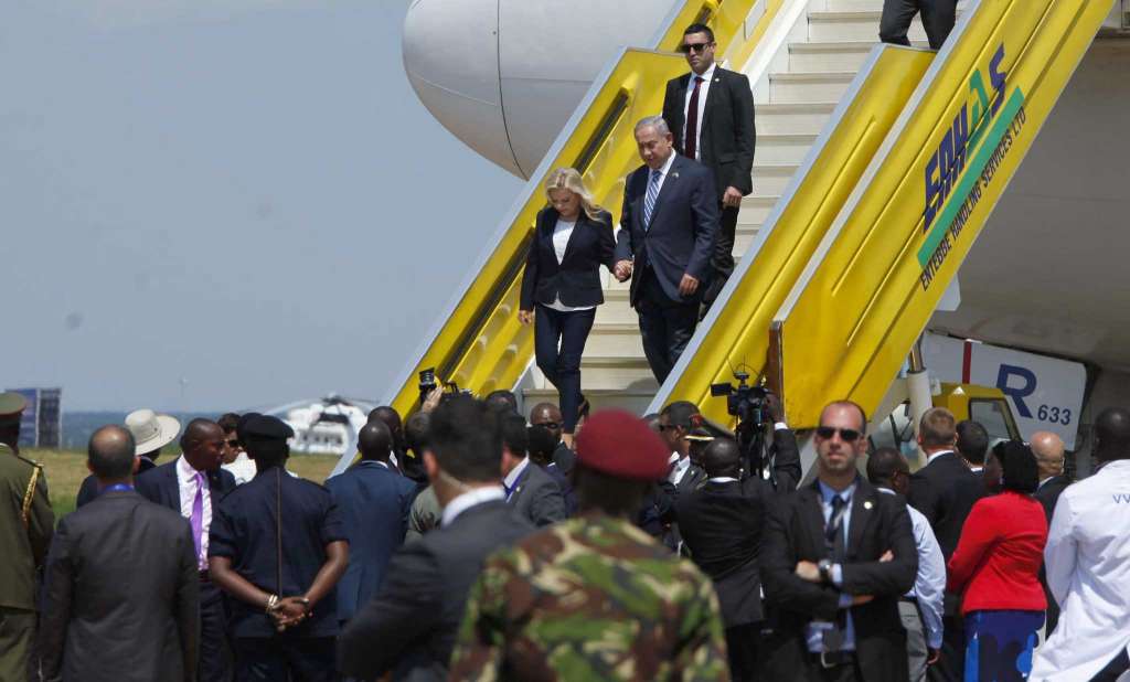 Israeli Prime minister Benjamin Netanyahu, on right on the planes steps on this arrival at Entebe Airport, Uganda.