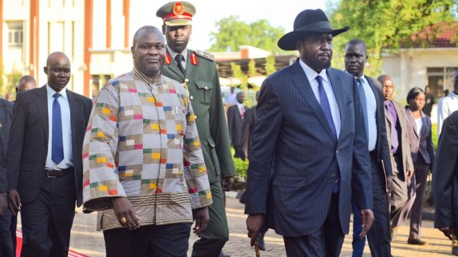 Riek Machar walks alongside President Salva Kiir on the red carpet recently.