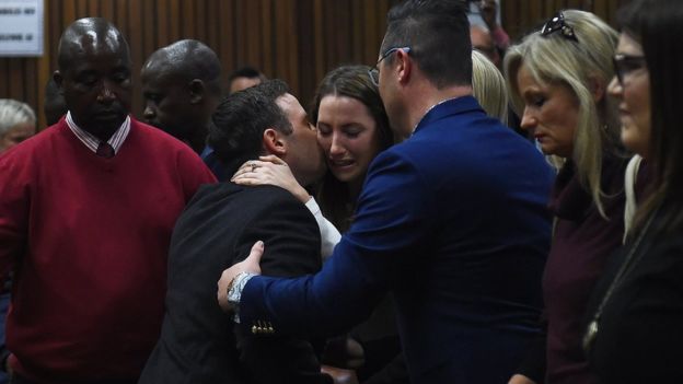 Pistorius hugged his sister Aimee before being taken away to prison. 