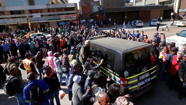 Journalists crowded around a van believed to be carrying Pistorius to jail after his sentencing.