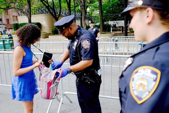 NYPD officers check bags at the east side before Macy's 4th of July Fireworks Independence Day celebrations in New York City.