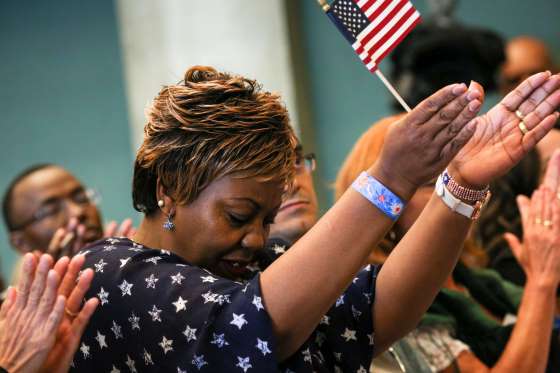 A new U.S. citizen reacts to calls for diversity inclusion by a speaker during an Independence Day naturalization ceremony held by U.S. Citizenship and Immigration Services for 503 people at Seattle Center in Seattle, Washington.