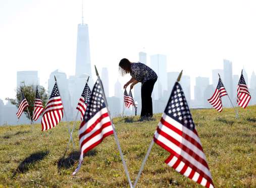 A woman arranges flags for the Fourth of July celebrations at Liberty State Park in Jersey City, New Jersey.