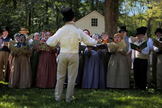 Members of the choir perform during a naturalization ceremony at Old Sturbridge Village in Sturbridge, Massachusetts.